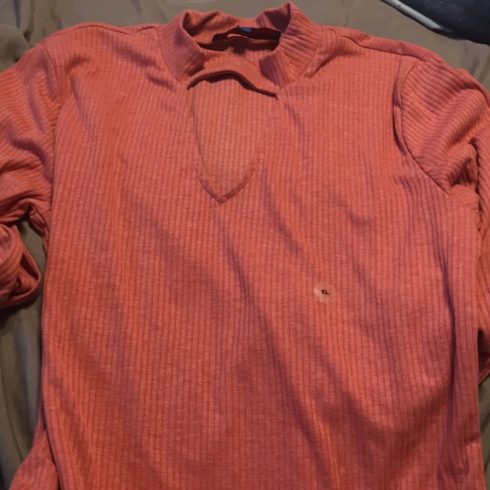 salmon long sleeve with design around the neck